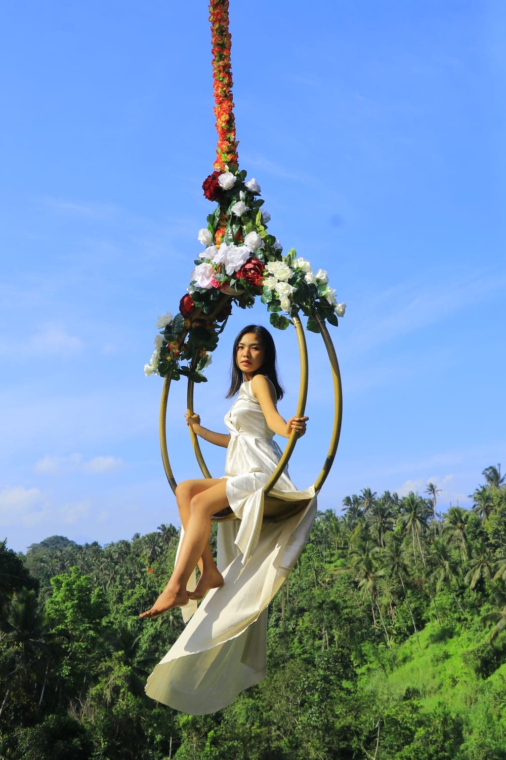 Guest in a flying dress on the Libra Swing at Aloha Ubud Swing