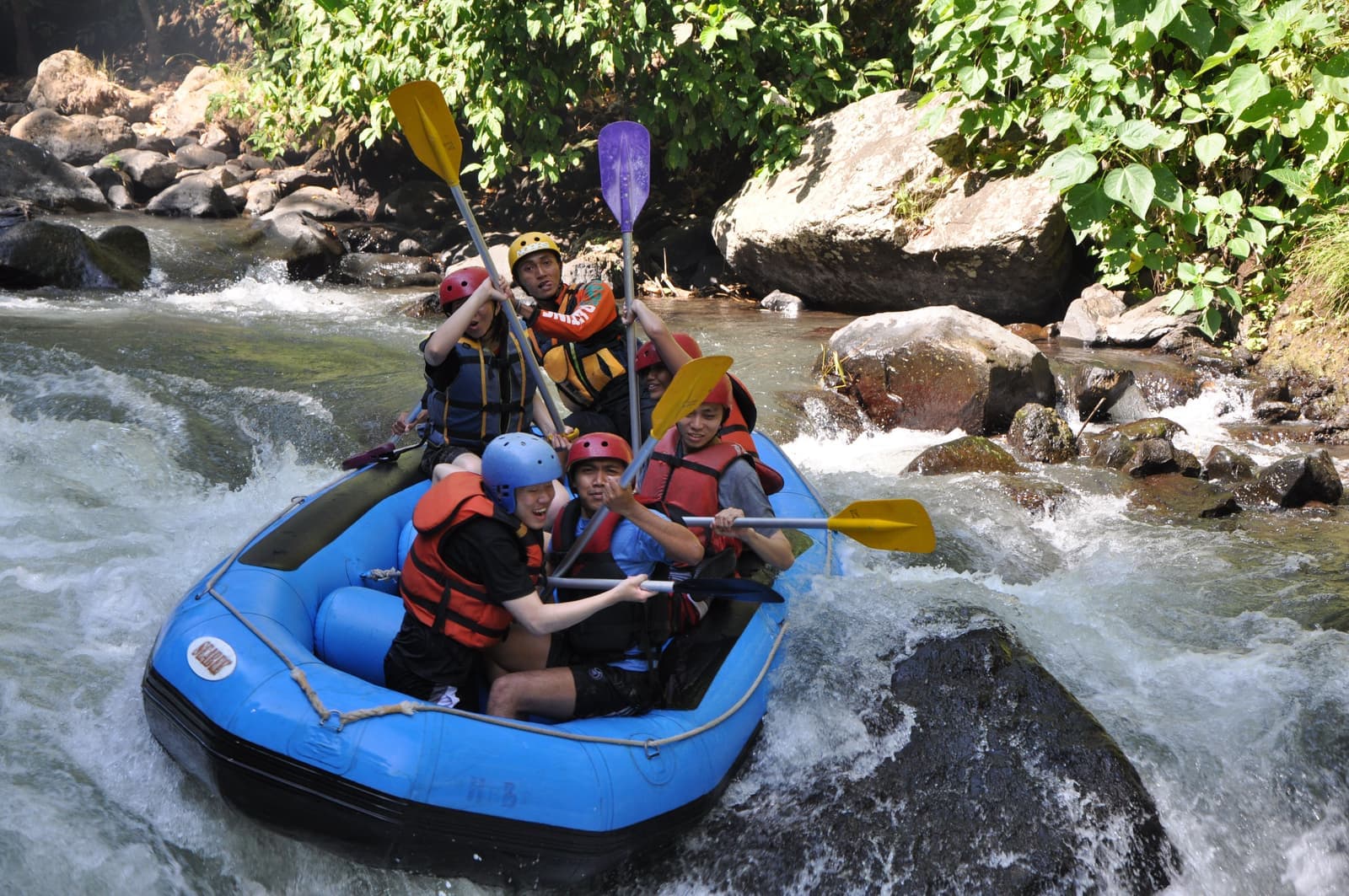 Ayung River rafting paddle team hitting Class II–III rapids near Ubud