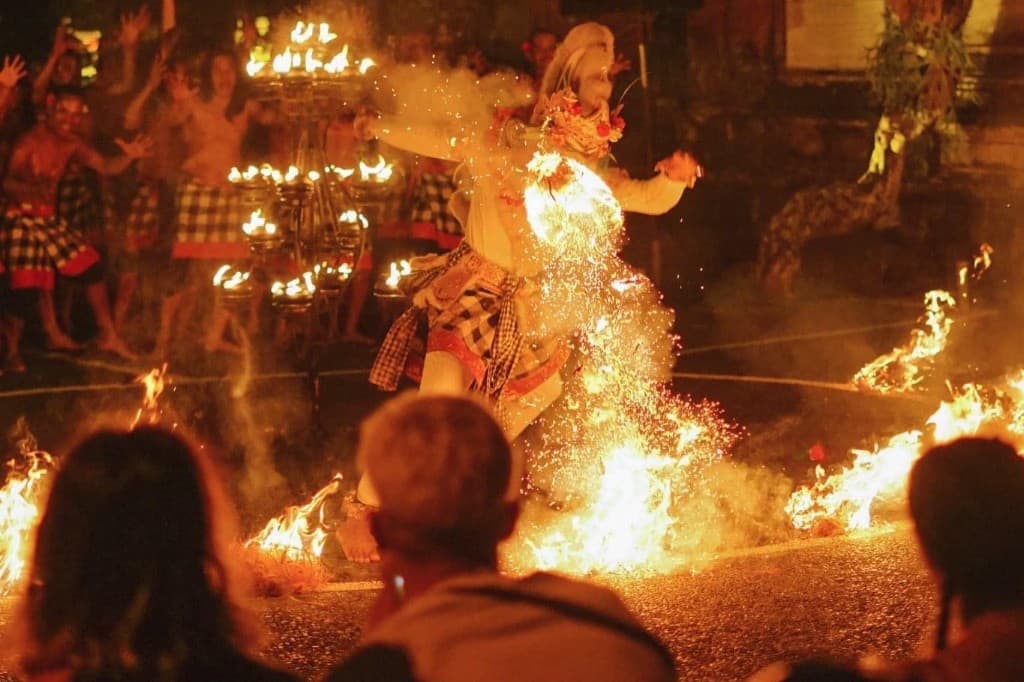 Dancer kicking through a wall of fire during the Ubud Kecak at Pura Dalem